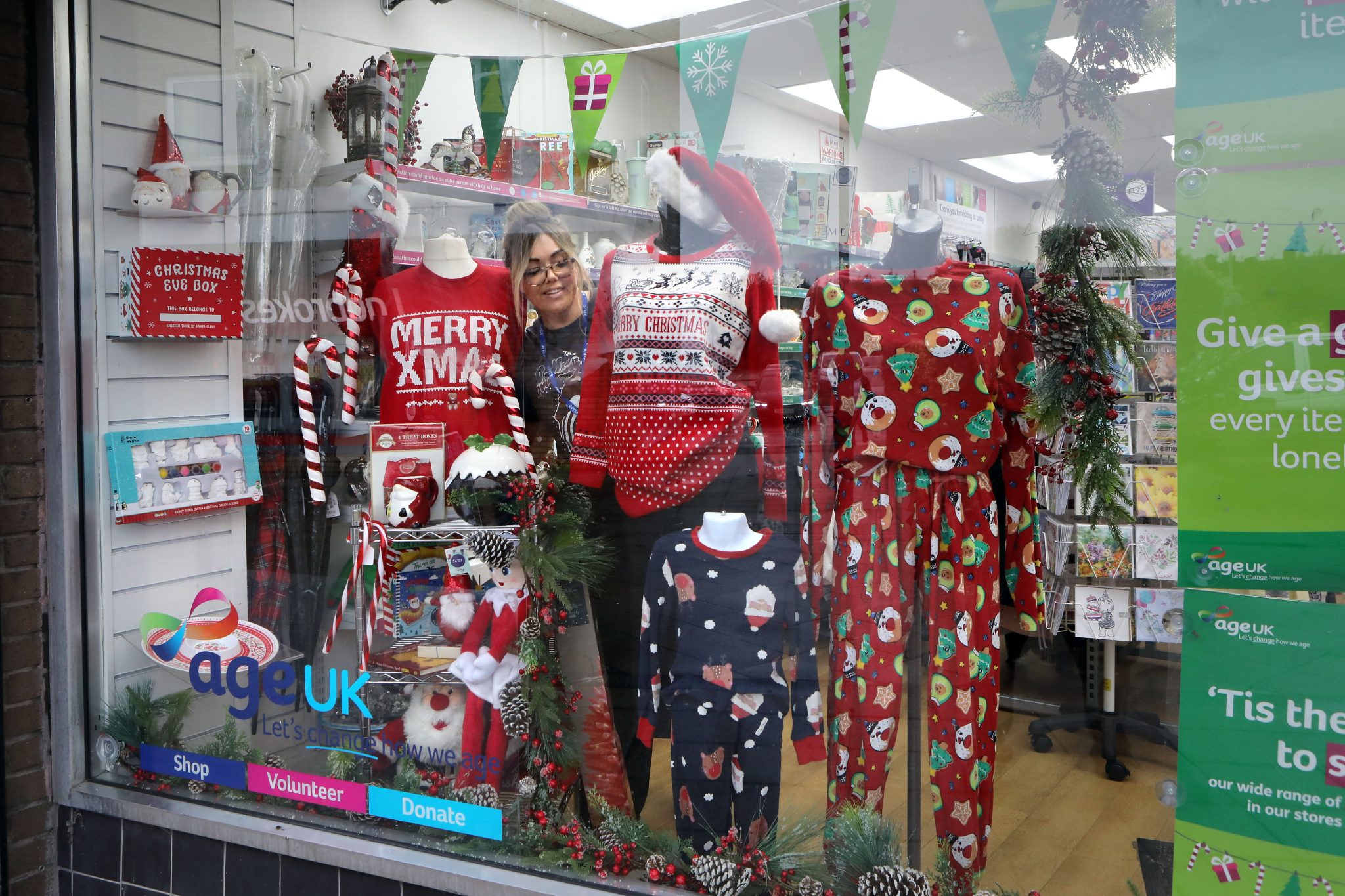 Jenna Boyle, shop manager of Age UK Chadderton and the Christmas window display